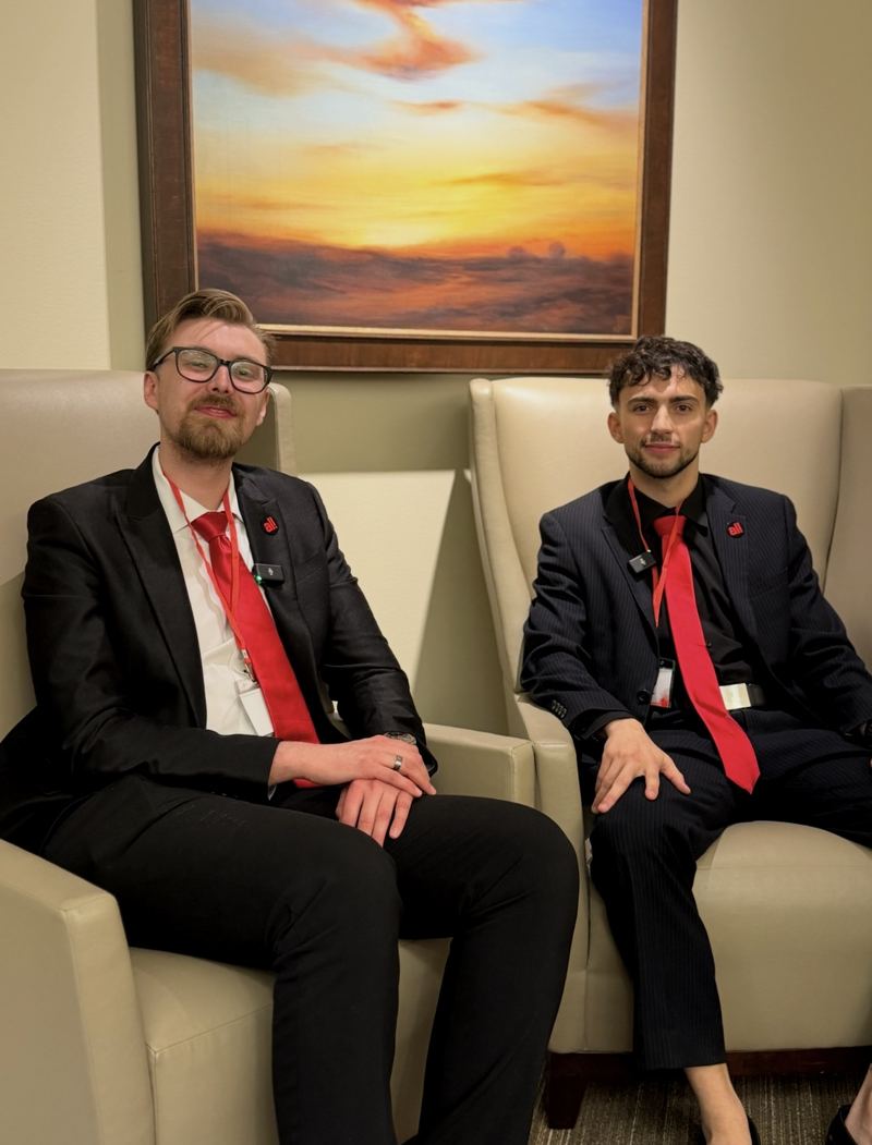Two LY Marketing leaders in suits seated in conversation