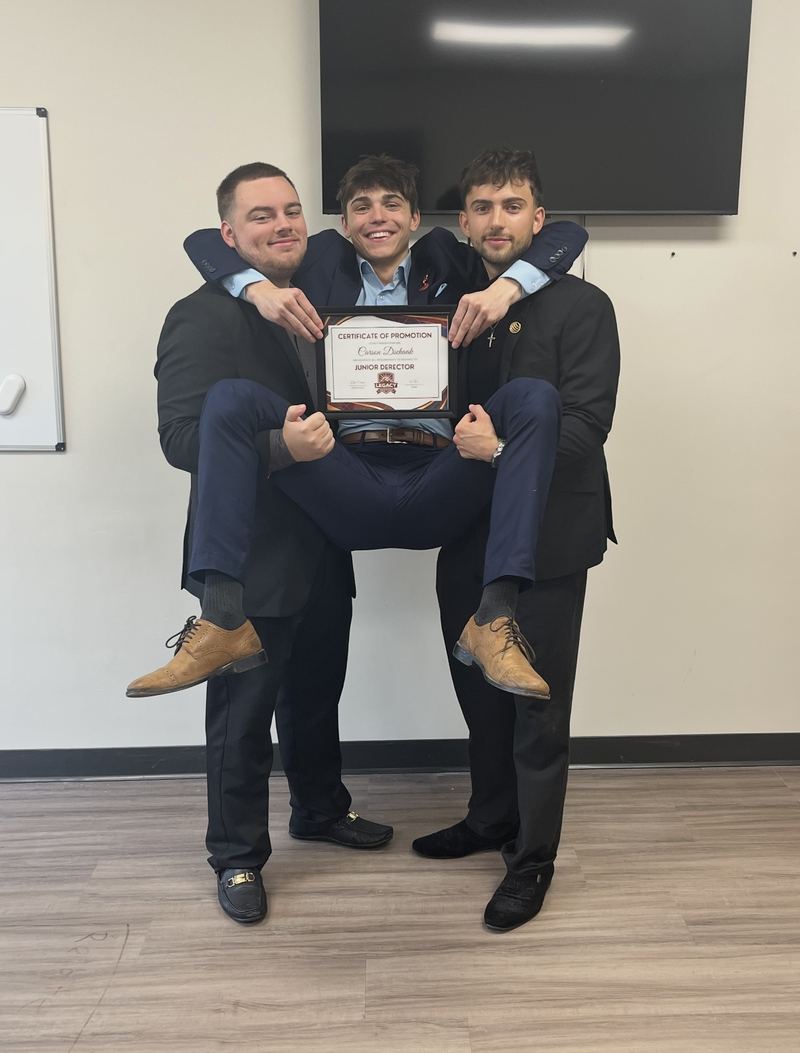 LY Marketing teammates lifting a newly promoted colleague