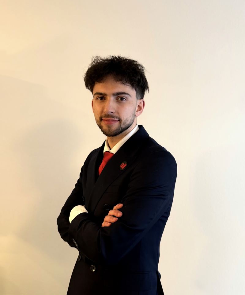 LY Marketing sales professional standing with arms crossed